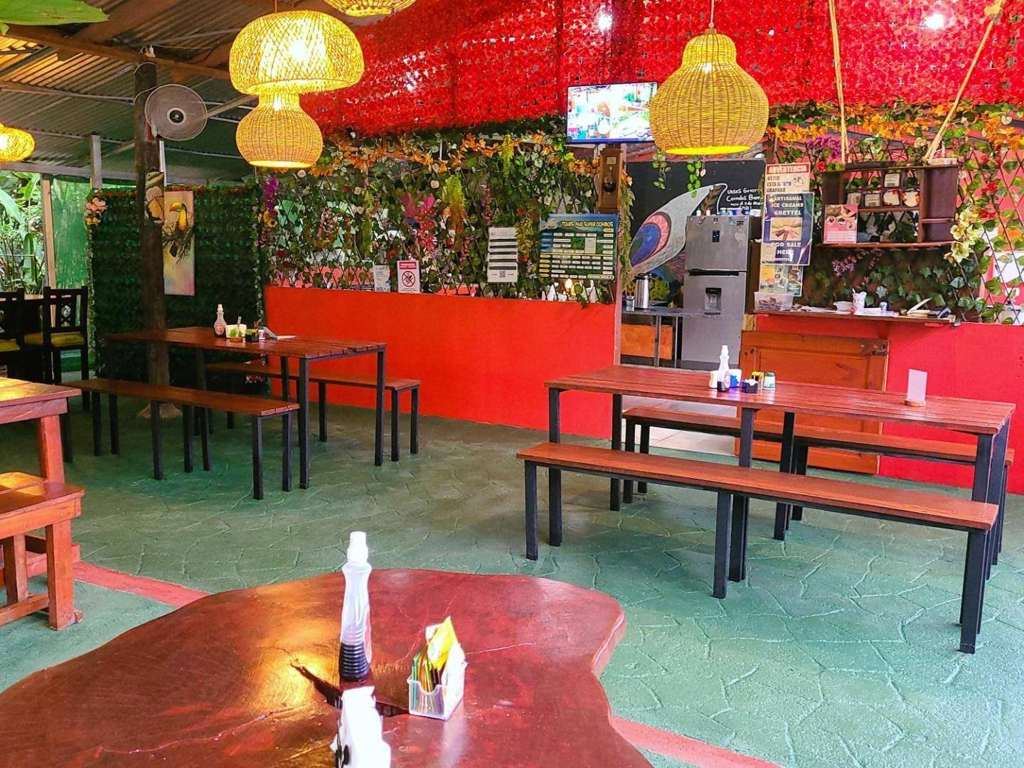 Open-air restaurant with wooden tables